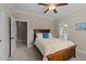 Comfortable bedroom featuring a ceiling fan, cozy carpet, and ensuite bathroom at 404 Wanderview Ln, Holly Springs, NC 27540