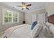 This bedroom has a large window letting in lots of natural light and a ceiling fan for comfort at 404 Wanderview Ln, Holly Springs, NC 27540