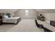 Bright bedroom featuring a comfortable bed, carpeted floors, desk, and ample natural light, perfect for relaxation and rest at 404 Wanderview Ln, Holly Springs, NC 27540