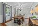 Elegant dining room featuring wainscoting, coffered ceilings, a chandelier, and a large window for natural light at 404 Wanderview Ln, Holly Springs, NC 27540