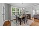 Bright dining room with a table set for four and plenty of natural light at 404 Wanderview Ln, Holly Springs, NC 27540