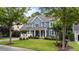 Charming two-story home with a beautifully landscaped front yard, attached garage, and welcoming entrance at 404 Wanderview Ln, Holly Springs, NC 27540