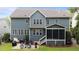 Well-maintained home featuring a rear exterior with a patio, backyard, and stylish blue siding, creating an inviting outdoor space at 404 Wanderview Ln, Holly Springs, NC 27540