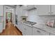 Bright kitchen features stainless steel appliances, granite countertops, and white cabinets at 404 Wanderview Ln, Holly Springs, NC 27540