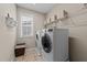 Functional laundry room featuring modern appliances and storage at 404 Wanderview Ln, Holly Springs, NC 27540