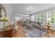 Stylish living area with views of the kitchen and dining room, featuring a comfortable sectional at 404 Wanderview Ln, Holly Springs, NC 27540