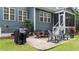 Inviting patio with outdoor seating and grill, perfect for entertaining or enjoying al fresco dining in the backyard at 404 Wanderview Ln, Holly Springs, NC 27540