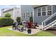 Inviting patio with outdoor seating and grill, perfect for entertaining or enjoying al fresco dining in the backyard at 404 Wanderview Ln, Holly Springs, NC 27540