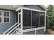 Cozy screened-in porch providing a relaxing space to enjoy the outdoors while being protected from insects and weather at 404 Wanderview Ln, Holly Springs, NC 27540