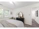 Relaxing bedroom with ceiling fan, dresser, and sitting area at 407 Gooseneck Dr # B1, Cary, NC 27513