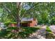 Beautiful brick building nestled among lush trees and landscaping with a sidewalk and driveway at 407 Gooseneck Dr # B1, Cary, NC 27513