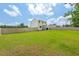 A sprawling backyard features a well-kept lawn and privacy fencing, creating a secure and spacious outdoor area at 411 Buxton St, Durham, NC 27713