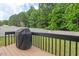 Relax on the deck overlooking the backyard surrounded by mature trees at 411 Buxton St, Durham, NC 27713
