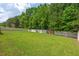 A large, well-maintained backyard enclosed by a tall privacy fence offers ample space for recreation and gardening at 411 Buxton St, Durham, NC 27713