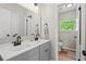 Modern bathroom with double sinks, updated fixtures, and stylish gray cabinets, creating a serene space at 411 Buxton St, Durham, NC 27713