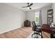 This bedroom is staged as an office with a ceiling fan and wood-look flooring at 411 Buxton St, Durham, NC 27713