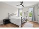 Cozy bedroom features a wrought iron bed frame, natural light, and light gray walls for a restful retreat at 411 Buxton St, Durham, NC 27713