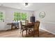 Bright dining room with wood floors, a large window, and stylish furniture at 411 Buxton St, Durham, NC 27713
