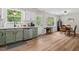 The kitchen has a dining table and the stainless steel dishwasher, sink, and green lower cabinets at 411 Buxton St, Durham, NC 27713