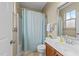 Well-lit bathroom with a shower, toilet, vanity, and mirror at 4124 Sykes St, Cary, NC 27519