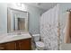 Bathroom with a single sink vanity and a shower tub featuring a shower curtain at 4124 Sykes St, Cary, NC 27519