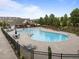 Large community pool area with lounge chairs and umbrellas for relaxing by the water at 4124 Sykes St, Cary, NC 27519