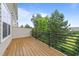 Outdoor deck shows wood plank flooring, metal railing, and view of the backyard landscaping at 4124 Sykes St, Cary, NC 27519