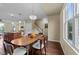Dining area shows wood table with chairs, hardwood flooring, and updated lighting fixture at 4124 Sykes St, Cary, NC 27519