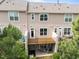 Back exterior of the property with a deck, patio, and lush greenery at 4124 Sykes St, Cary, NC 27519