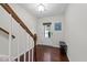 Foyer featuring hardwood floors, staircase, and natural light from the front door at 4124 Sykes St, Cary, NC 27519