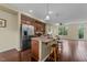 Kitchen area boasts island with barstool seating, stainless appliances, and modern lighting at 4124 Sykes St, Cary, NC 27519