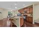 Modern kitchen features stainless steel appliances, granite countertops, and a large island at 4124 Sykes St, Cary, NC 27519