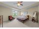 Neutral main bedroom with a ceiling fan, carpet, and large windows for lots of light at 4124 Sykes St, Cary, NC 27519