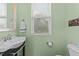 Cozy powder room shows vanity with mirror, window, and modern fixtures at 4124 Sykes St, Cary, NC 27519