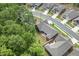 An aerial view showcases the home with lush green trees, a landscaped yard, and backyard patio at 428 Crayton Oak Dr, Cary, NC 27519