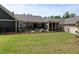 A well-maintained backyard with a covered patio and lush green lawn enclosed by a black fence at 428 Crayton Oak Dr, Cary, NC 27519