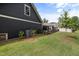 Backyard with a lush green lawn, black aluminum fence and landscaped garden at 428 Crayton Oak Dr, Cary, NC 27519