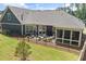 Aerial view of a backyard featuring a covered patio with outdoor furniture and a manicured lawn at 428 Crayton Oak Dr, Cary, NC 27519
