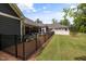 Well-maintained backyard featuring a black fence, beautiful plantings and screened in porch at 428 Crayton Oak Dr, Cary, NC 27519