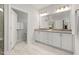 Bathroom featuring double vanity with ample storage, decorative mirrors, and modern lighting fixtures at 428 Crayton Oak Dr, Cary, NC 27519