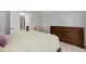 Bedroom featuring neutral tones, a dresser, walk-in closet, and cozy chair at 428 Crayton Oak Dr, Cary, NC 27519