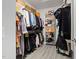 Bright walk-in closet features ample shelving and hanging space for clothes and storage boxes at 428 Crayton Oak Dr, Cary, NC 27519