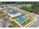 Aerial view of community pool, tennis court, clubhouse, parking and surrounding homes at 428 Crayton Oak Dr, Cary, NC 27519