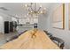 Dining room with views of the modern kitchen, featuring a unique table and stylish lighting at 428 Crayton Oak Dr, Cary, NC 27519