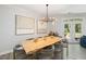 Dining room featuring a live edge table, modern chandelier, and access to an outdoor area at 428 Crayton Oak Dr, Cary, NC 27519