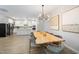 Dining room with a unique live-edge table, modern light fixture, and open view to the kitchen at 428 Crayton Oak Dr, Cary, NC 27519