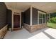 Cozy covered front porch with stone accents and a welcoming entrance at 428 Crayton Oak Dr, Cary, NC 27519