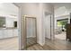 Hallway view showing the transition from bath to bedroom with hardwood floors and natural light at 428 Crayton Oak Dr, Cary, NC 27519