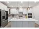 Bright kitchen featuring stainless steel appliances, a center island, and stylish pendant lighting at 428 Crayton Oak Dr, Cary, NC 27519