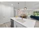 Open-concept kitchen with a large island that transitions seamlessly into the dining and living areas at 428 Crayton Oak Dr, Cary, NC 27519